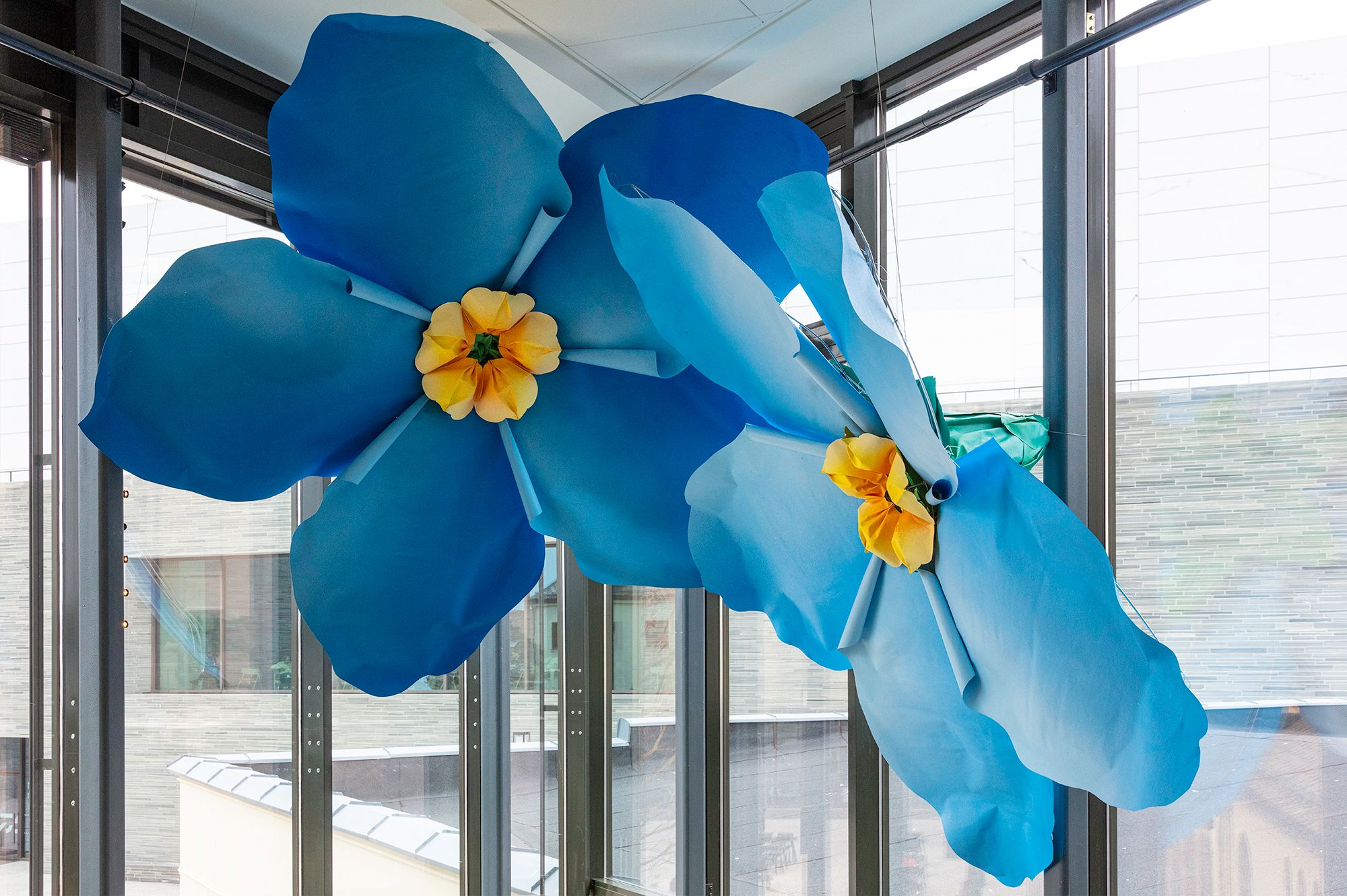 Art installation of to huge flowers hanging from the ceiling in the Nobel Peace Center