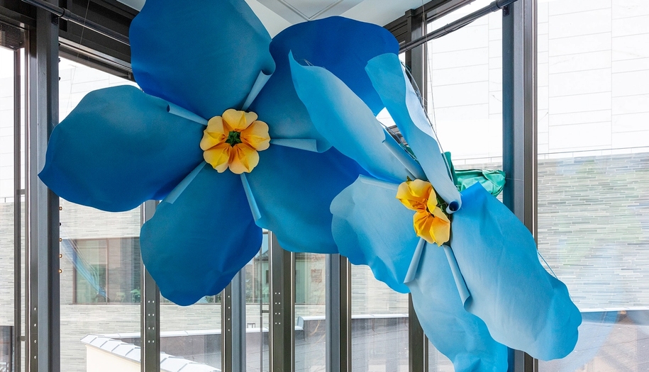 Art installation of to huge flowers hanging from the ceiling in the Nobel Peace Center