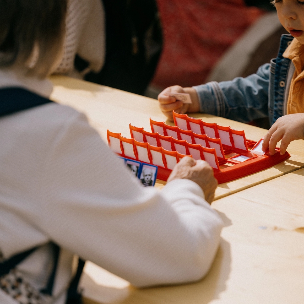 kid playing who's who with his grandmother.
