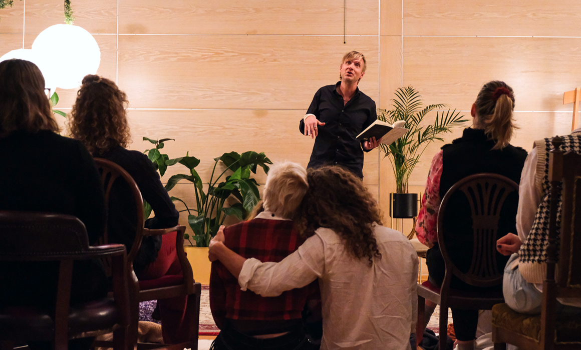 poets evening, one person performing while people are watching.