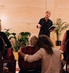 from poetry session, audience watching man performing.