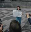 Journalist Sonya Groysman holds up the warning the authorities require her to use, as a "foreign agent".