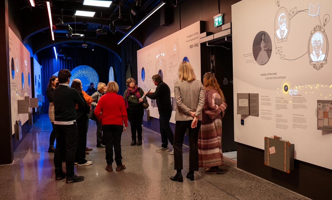 A group of people getting a guided tour in the exhibitions.