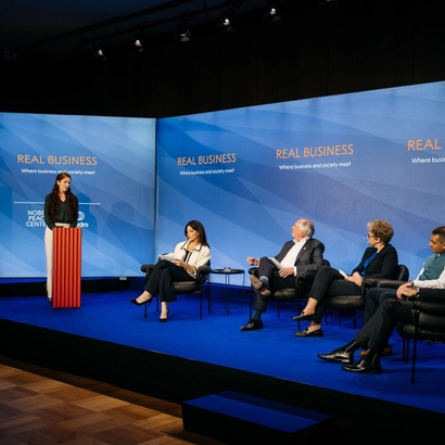 real business event with panelists on stage.