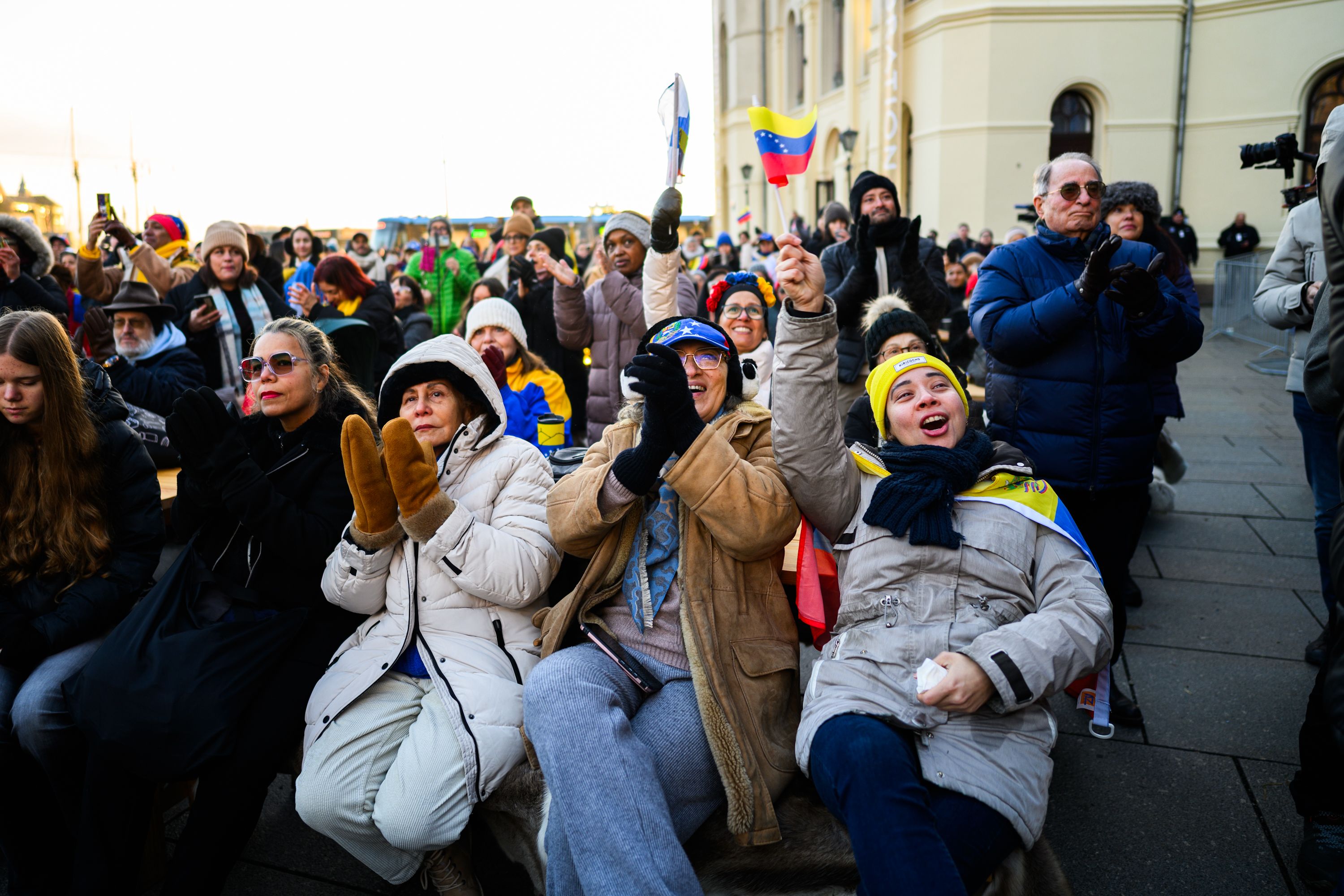 Crowds cheering while watching the Nobel Peace Prize ceremony outside at the peoples peace prize celebration