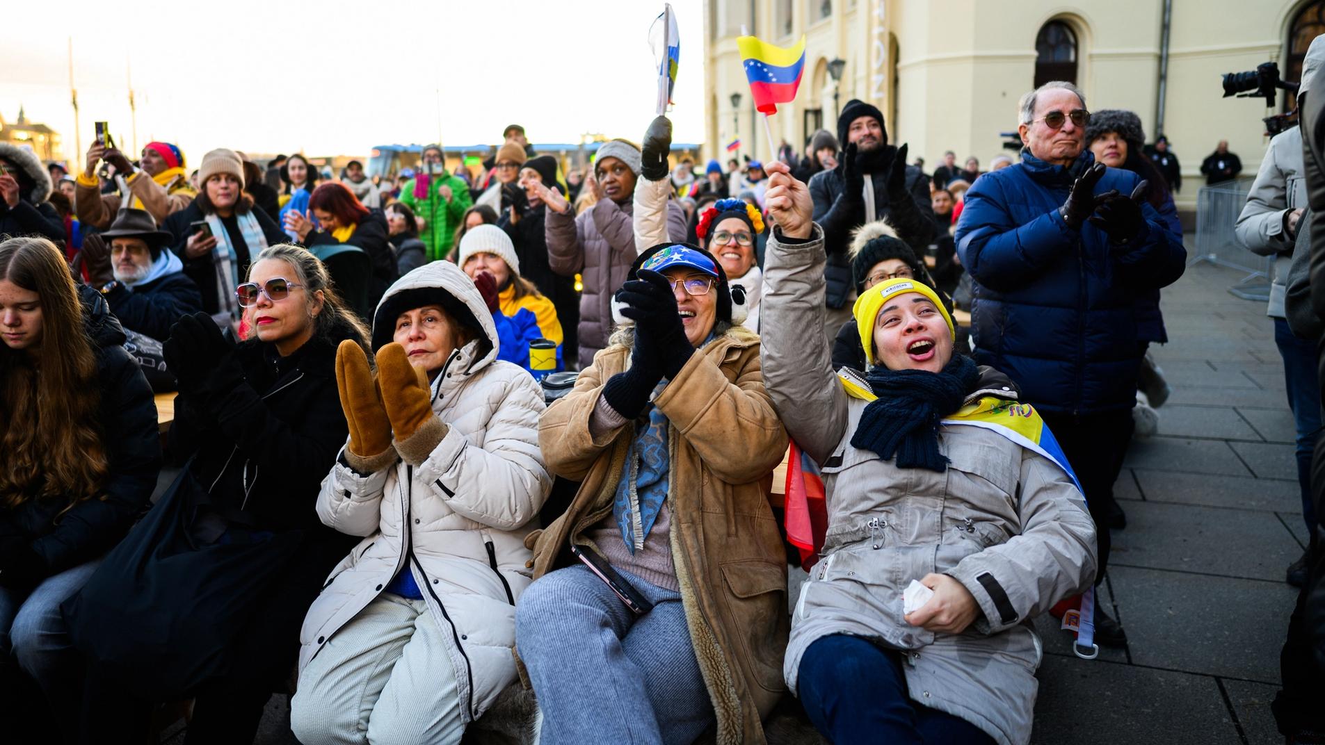 Crowds cheering while watching the Nobel Peace Prize ceremony outside at the peoples peace prize celebration