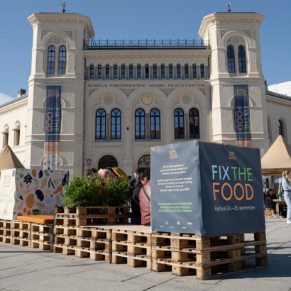 the fasade of the nobel peace center, with a sign saying fix the food.