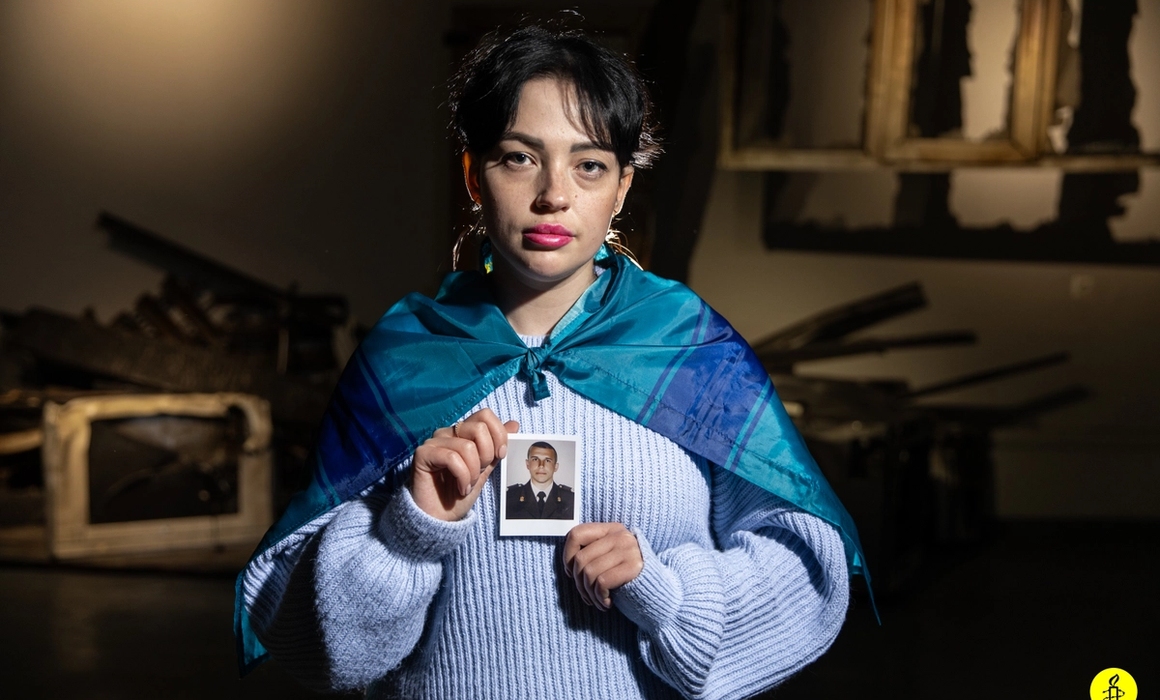 woman holding an image of a soldier.