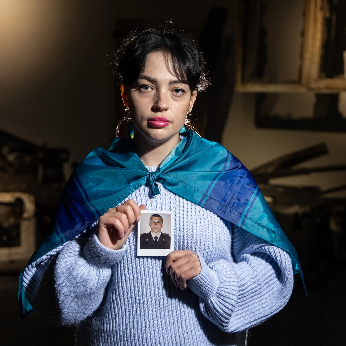 woman holding an image of a soldier.