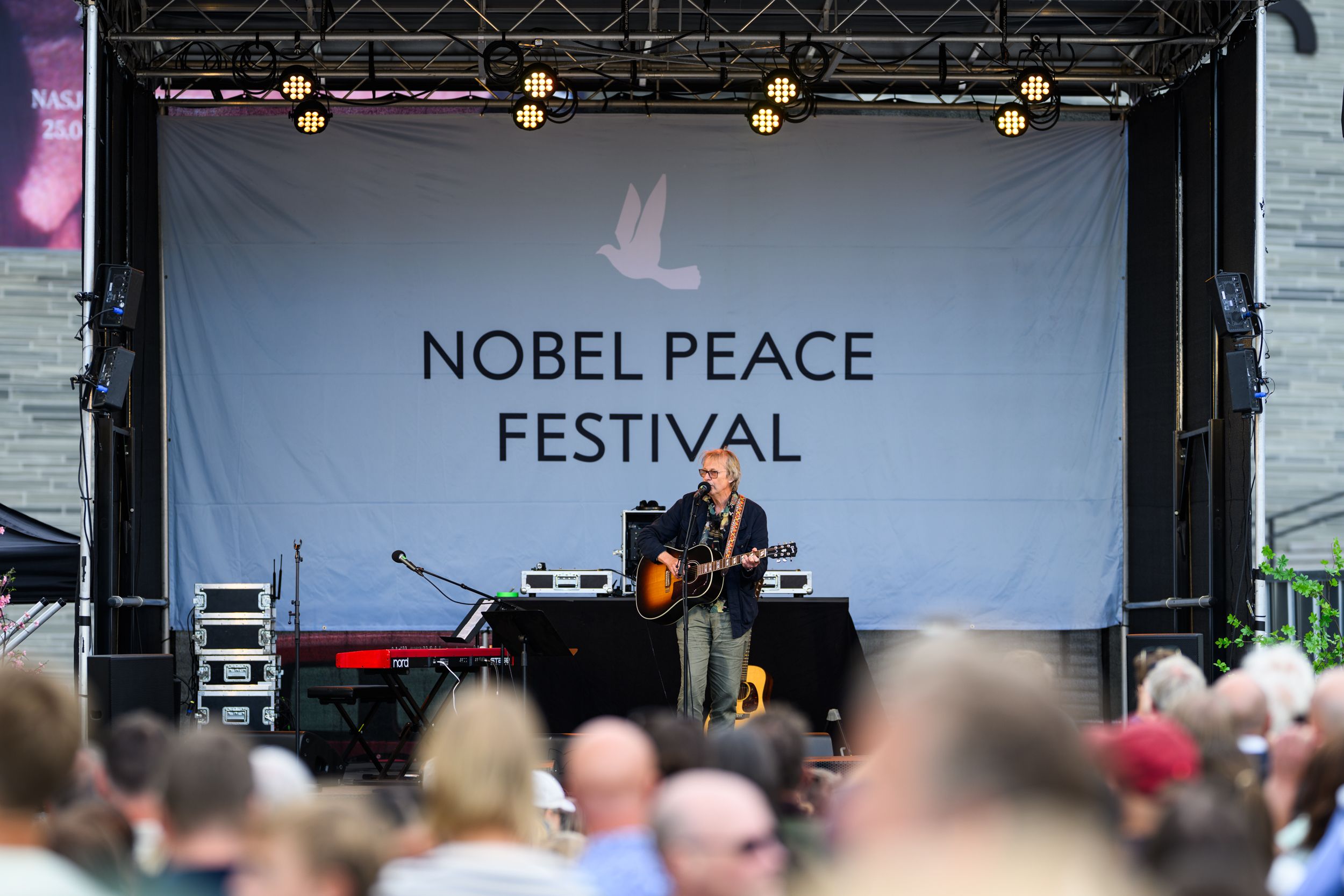 Lars Lillo On stage with guitar singing.