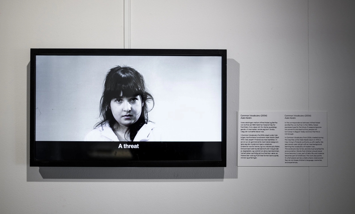 display screen from exhibition, showing girl in black and white