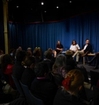 A conversation in the mandela room, panel on stage and audience.