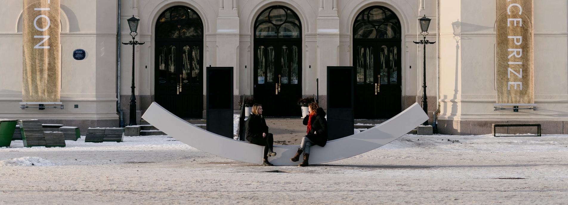 The fasade of the nobel peace center, with the dialogue bench in front