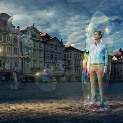 a man standing with a bubble around him in the street.