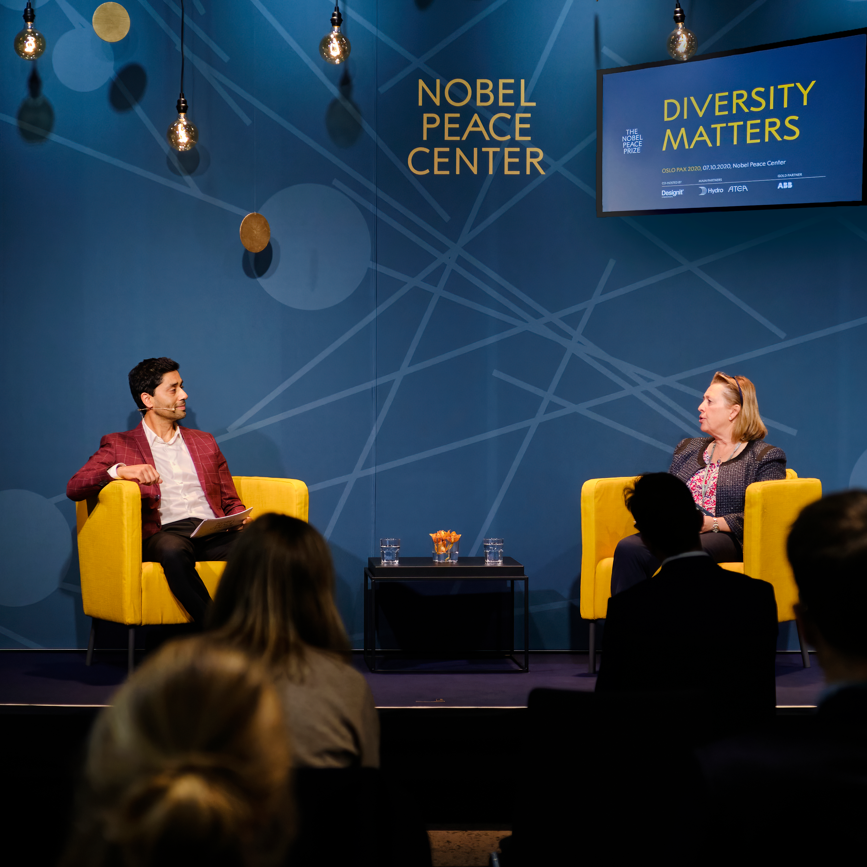 two people on stage- talking