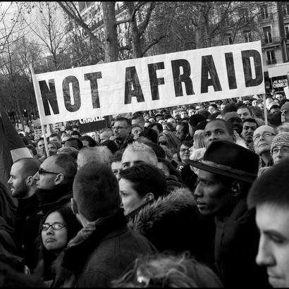 Protestors with a sign saying "not afraid"