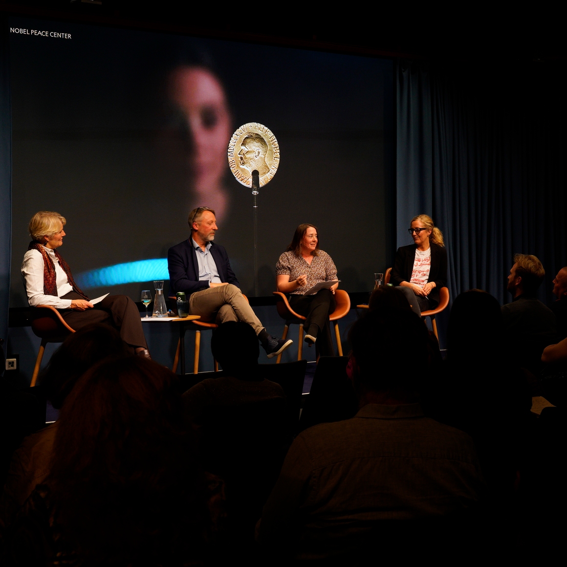 a panel on stage, conversing
