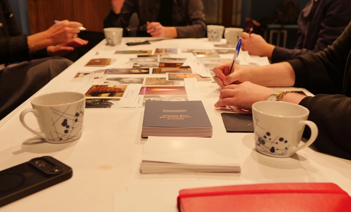 a table full of coffe cups and images and hands working-