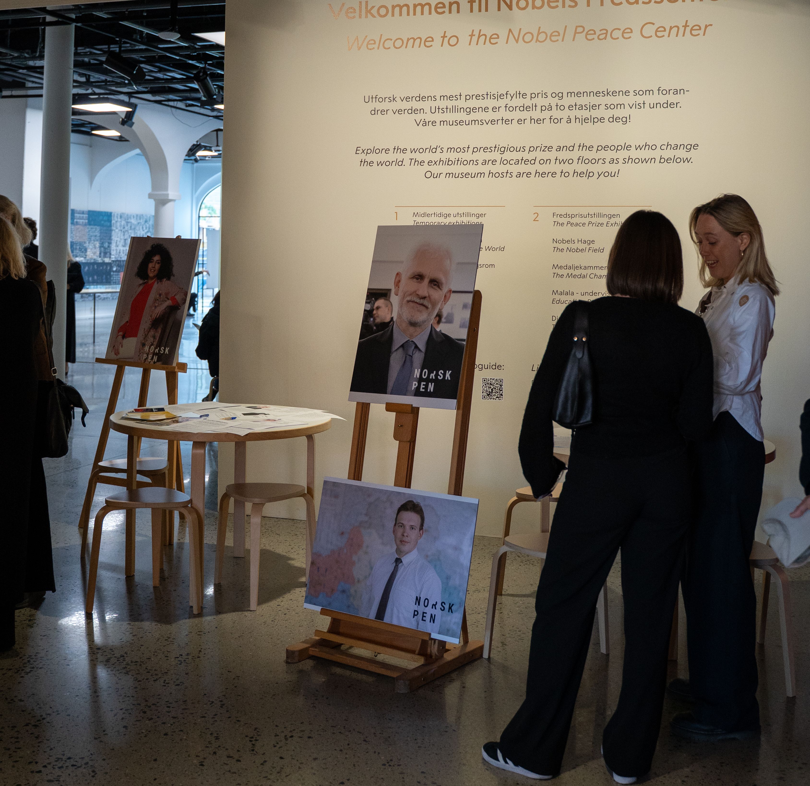 The letter writing, with posters of narges mohammadi and ales bialiatski.