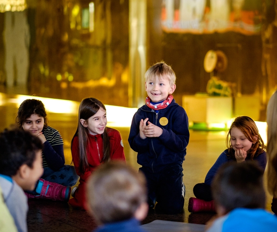 children at the nobel peace center talking together