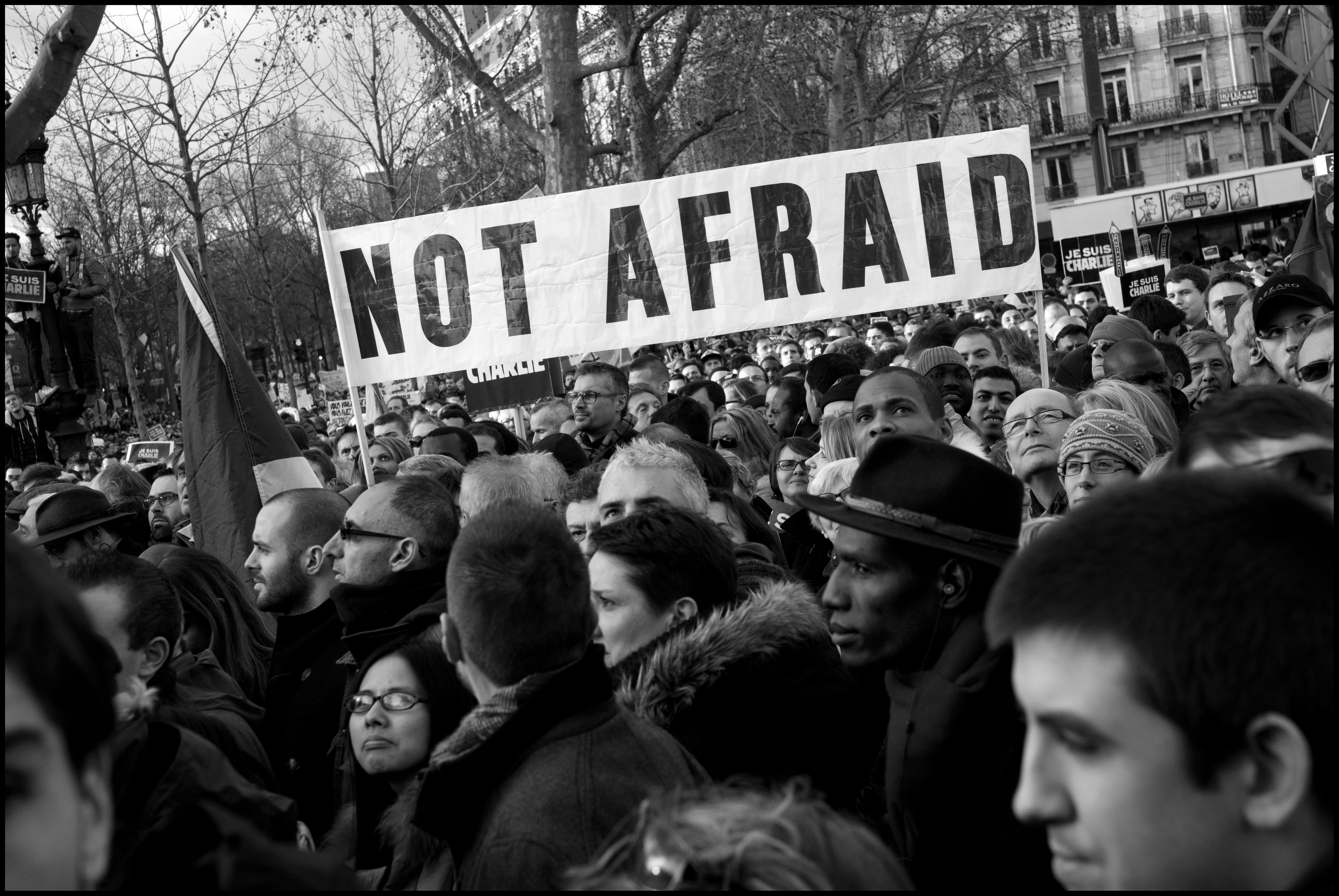 Protestors with a sign saying "not afraid" 