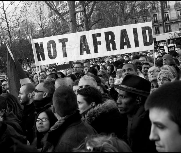 Protestors with a sign saying "not afraid" 