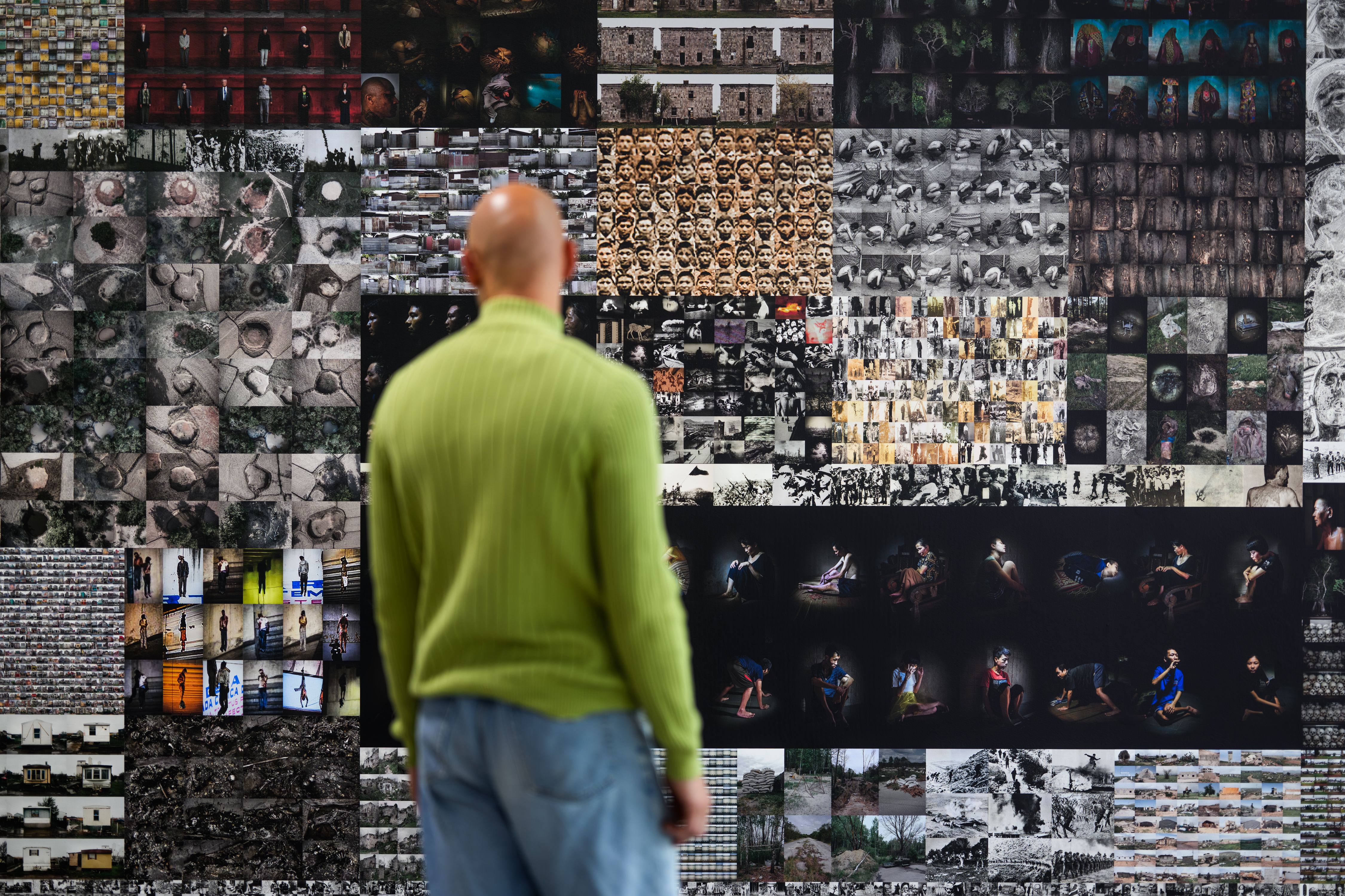 The exhibition, person standing in front of an installation