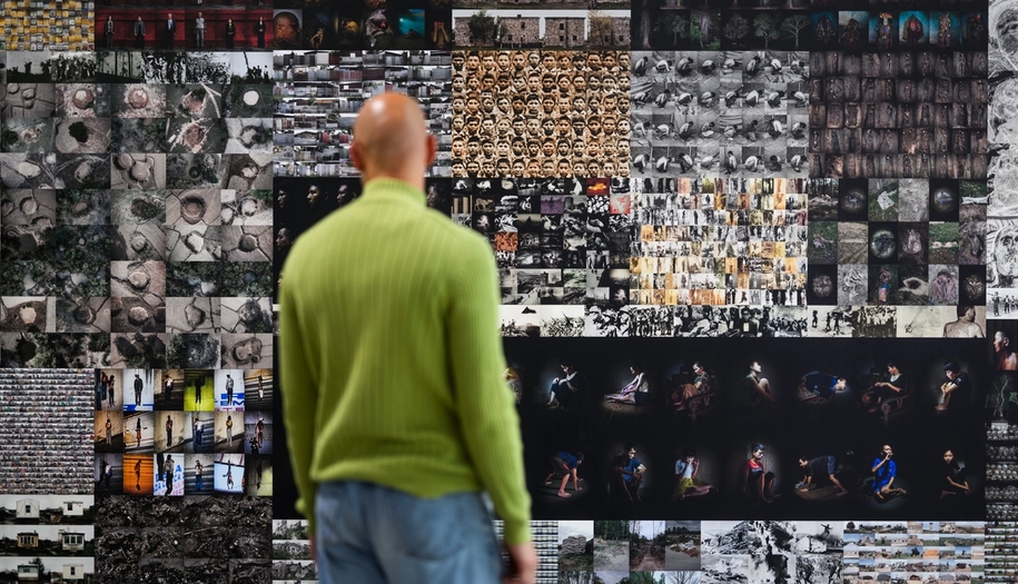 The exhibition, person standing in front of an installation
