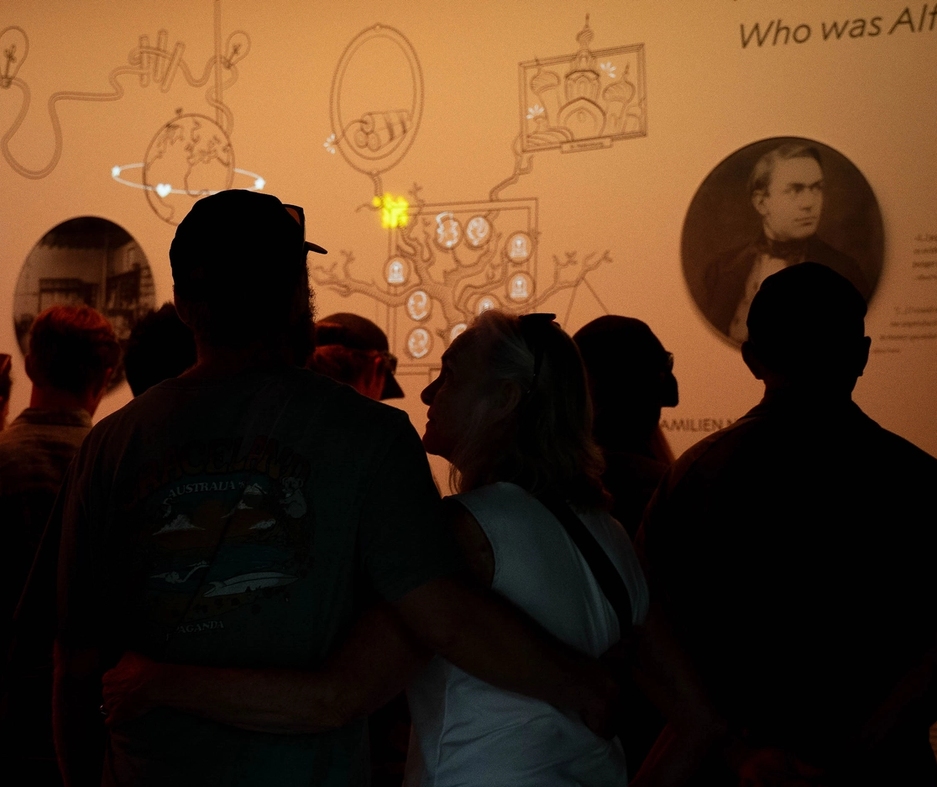 People inside the nobel peace center enjoying an exhibition in the evening.