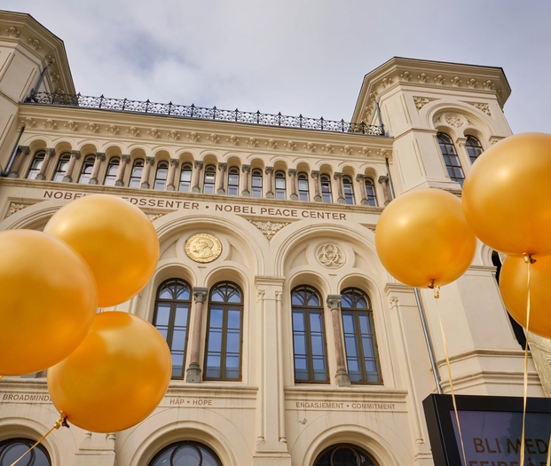 The Nobel Peace Center viewed from the outside, with golden ballons outside.