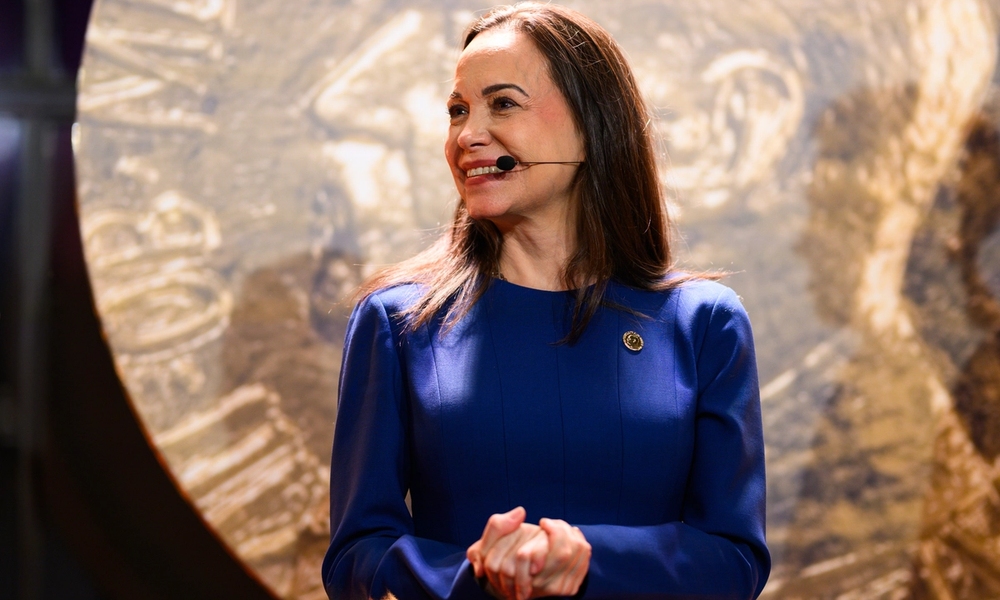 Maria Corina on stage smiling