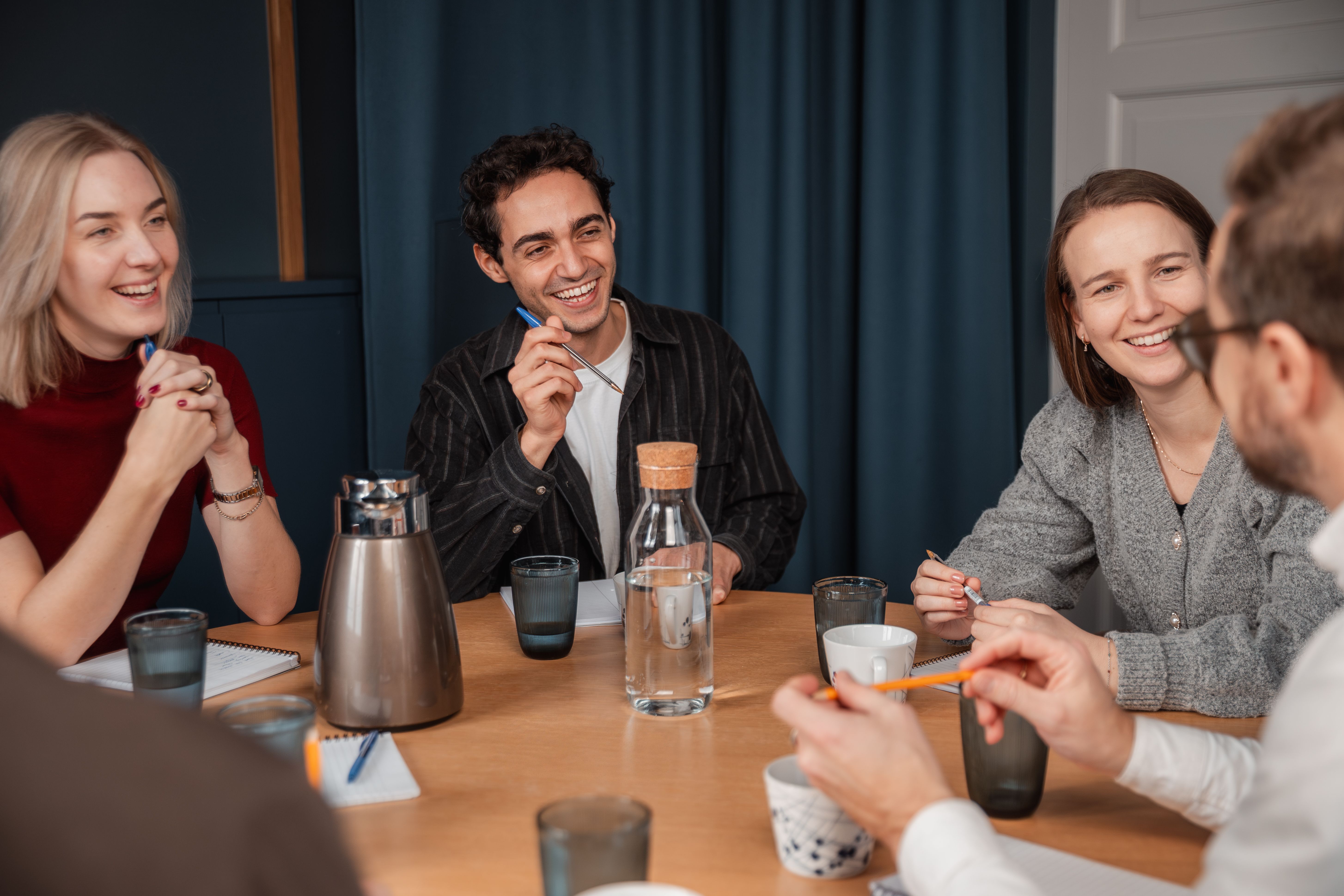People having a joyful conversation in a meeting.