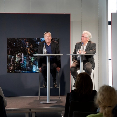 Image of event, two speakers on stage.