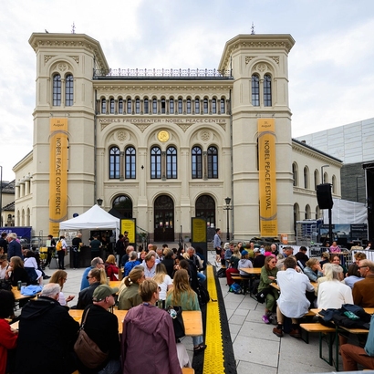 the front of the nobel peace center with plenty of people visiting.