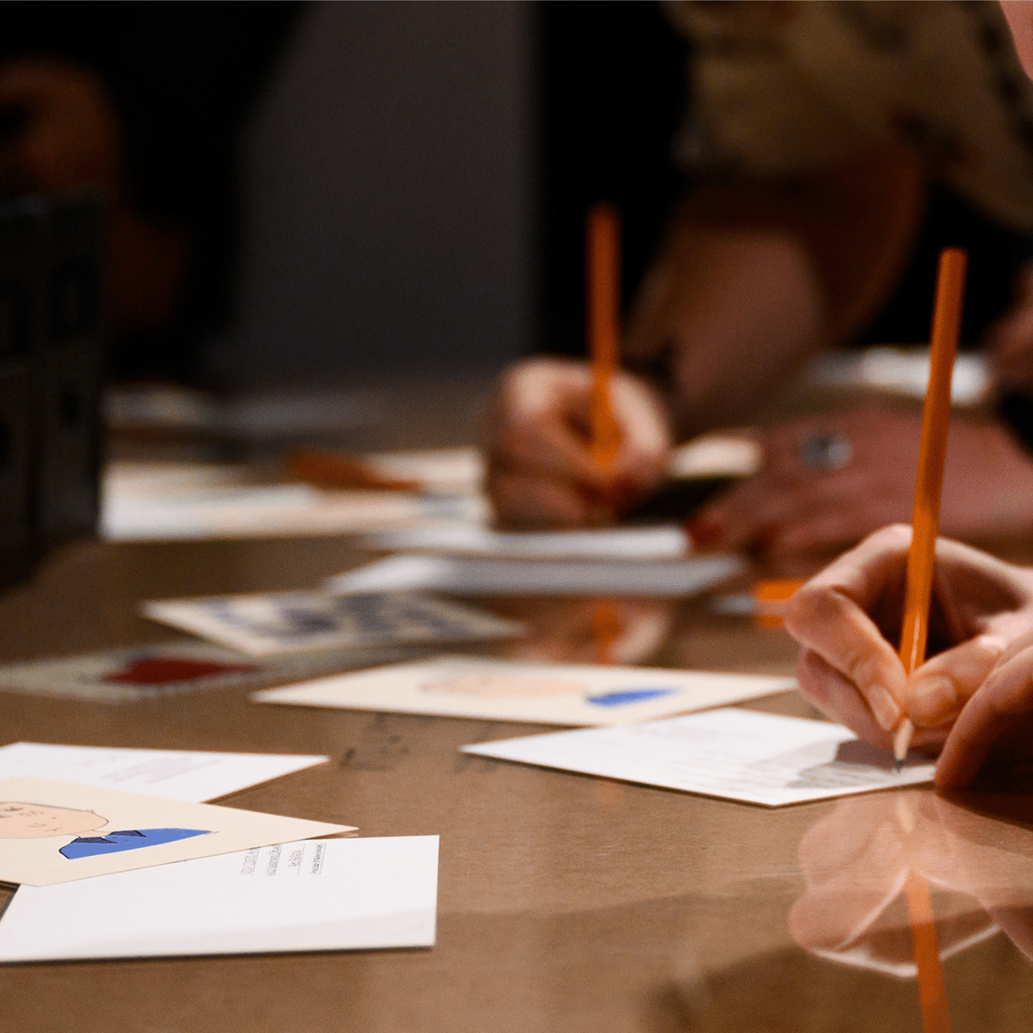 people writing postcards.