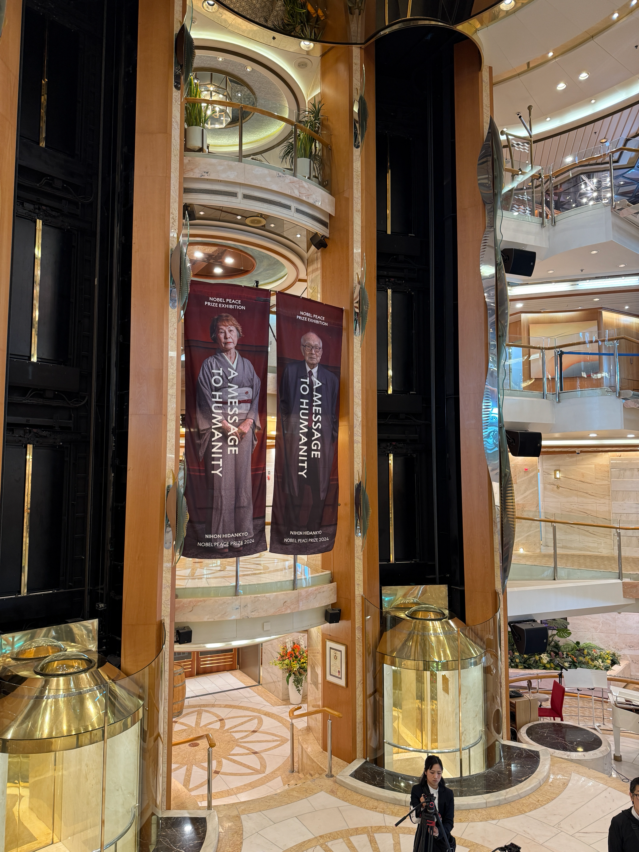 the peace boat grand hall had banners of the exhibition hanging up.