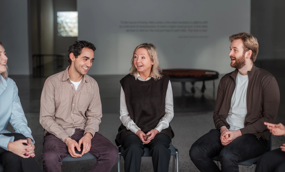 3 people having a conversation, light mood and laughs.