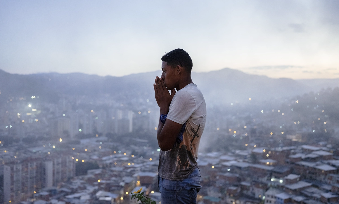 man on a viewpoint with caracas in the background.
