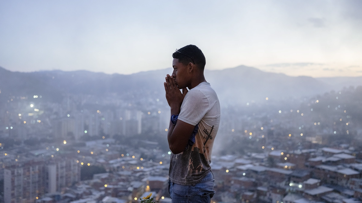 man on a viewpoint with caracas in the background.