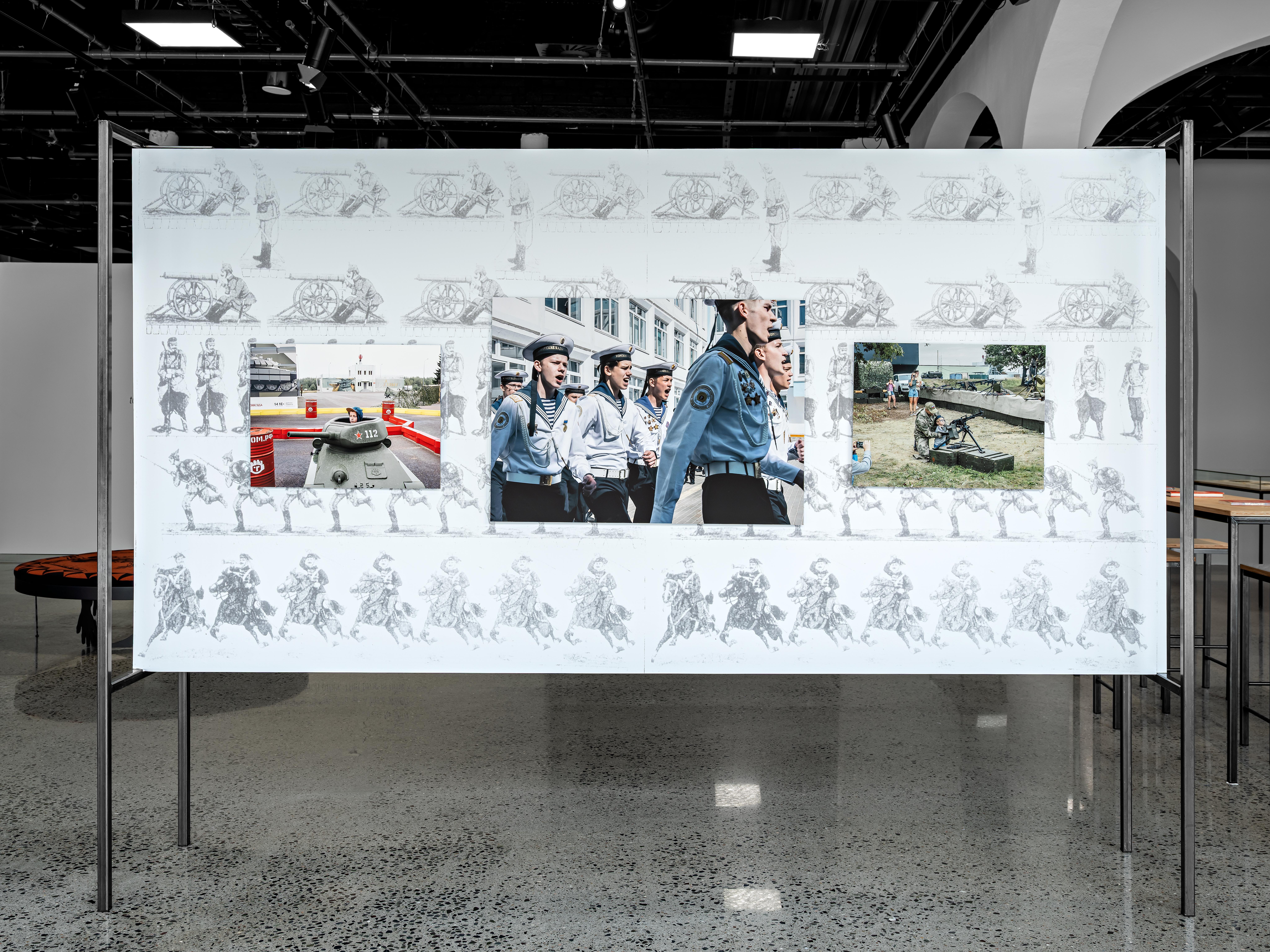 Showing propaganda in action, photos shown in the exhibition war is peace.