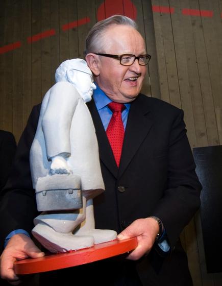 Martti Ahtisaar som holder mini statue av seg selv