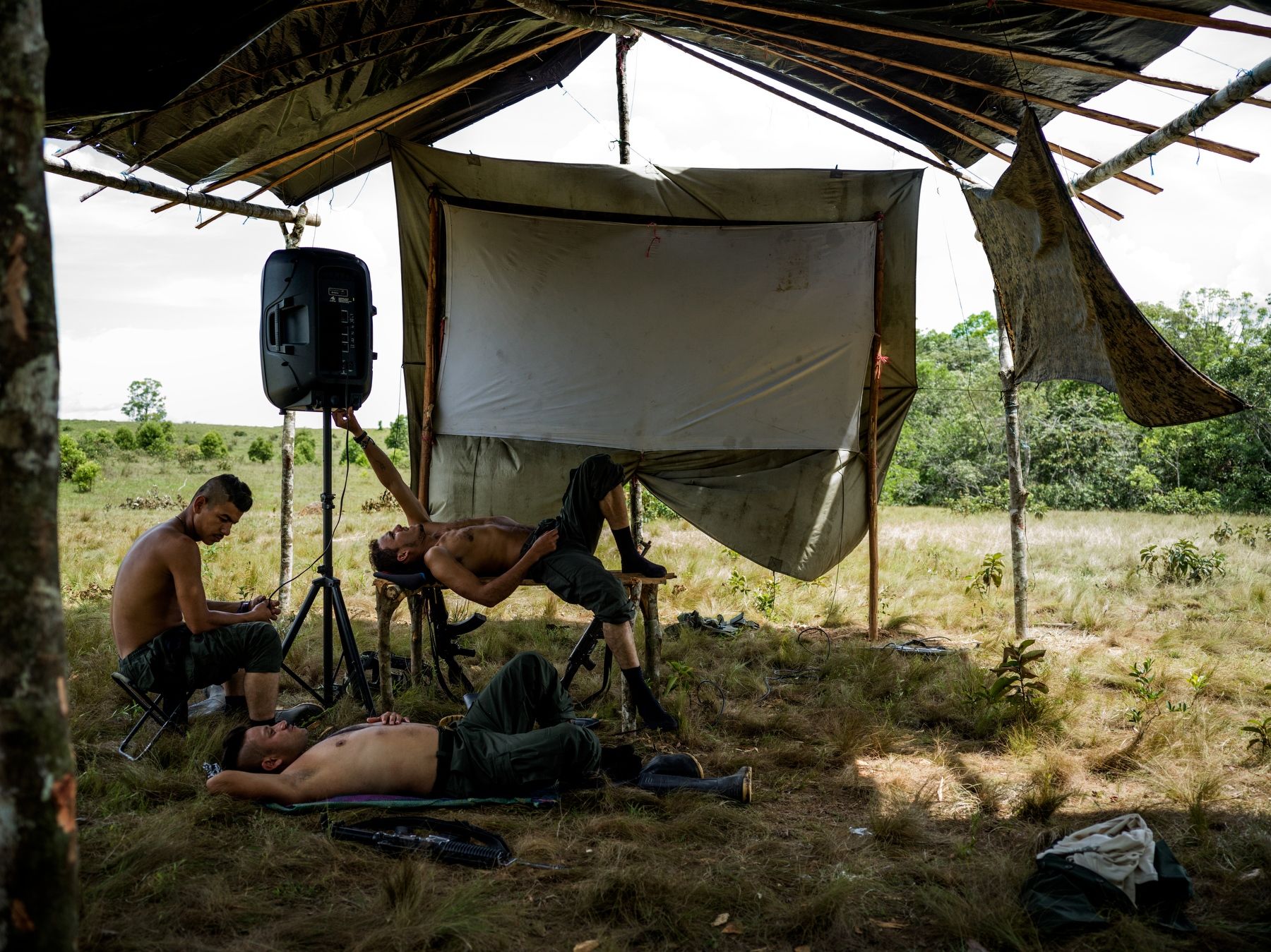 Sebastian Tores, 28, 12 years with FARC (resting on the table) with his comrades killing time during the ceasefire.
