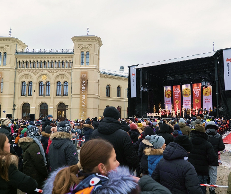 Foran nobels fredssenter, folkemengde og en scene.