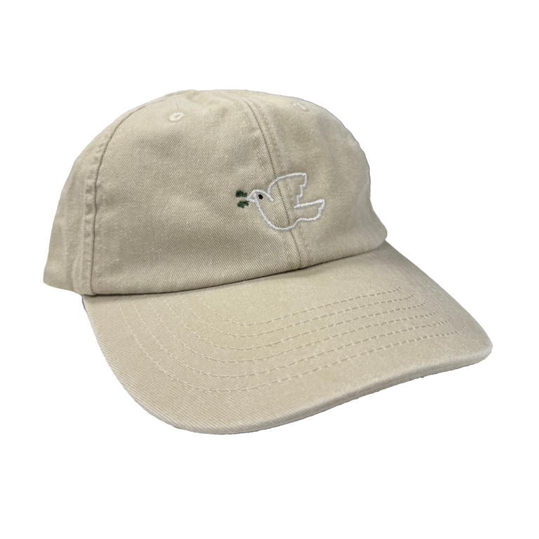En beige caps med illustrasjon av en due brodert på.