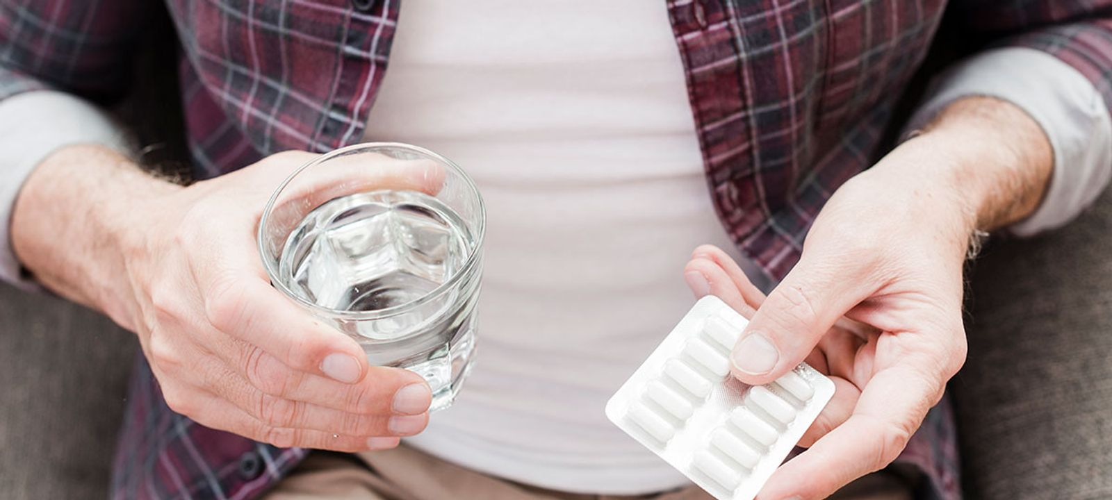 Older adult managing multiple medications, highlighting the risks of complex health plans.