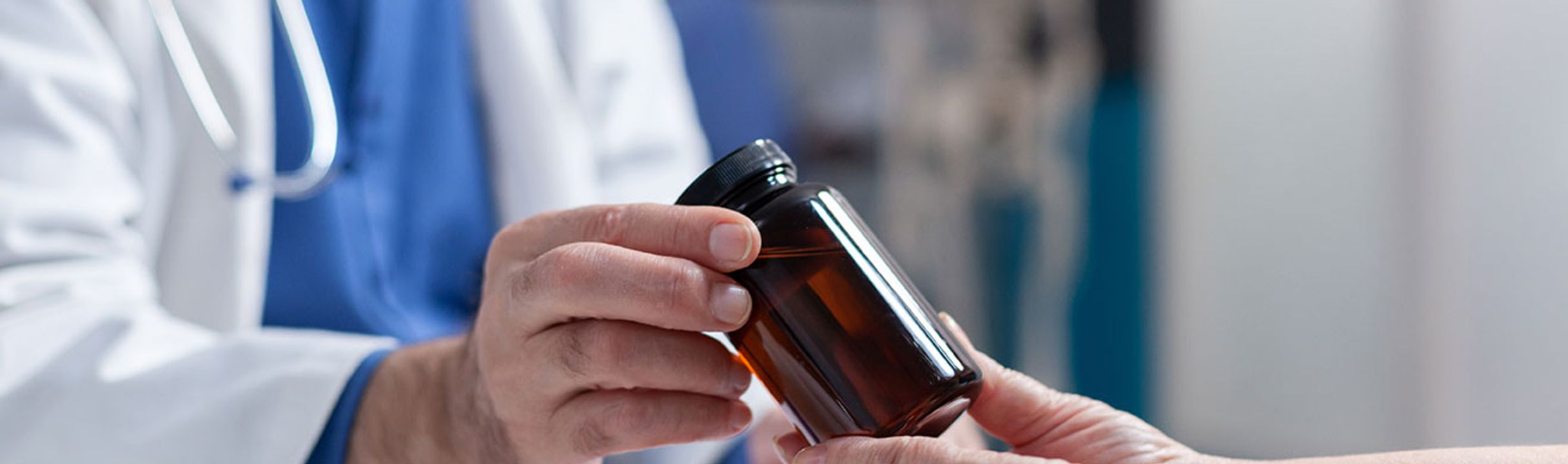 Doctor reviewing medications with a patient as part of simplifying health plans.