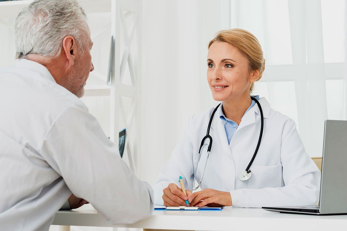 Doctor discussing personalized healthcare options with an older patient during an unhurried visit.
