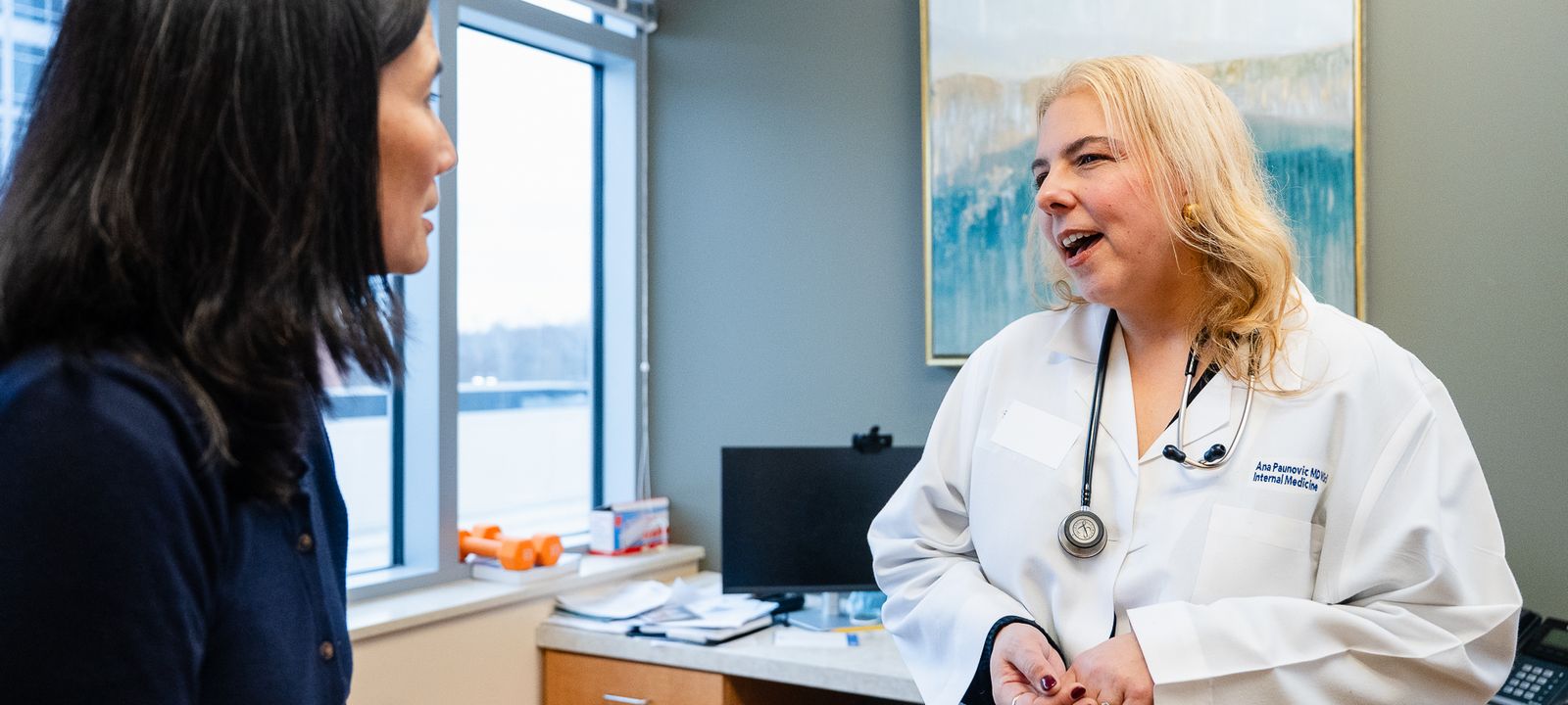Dr. Ana Paunovic speaking with a patient during a consultation - Complete Concierge Care in Bethesda