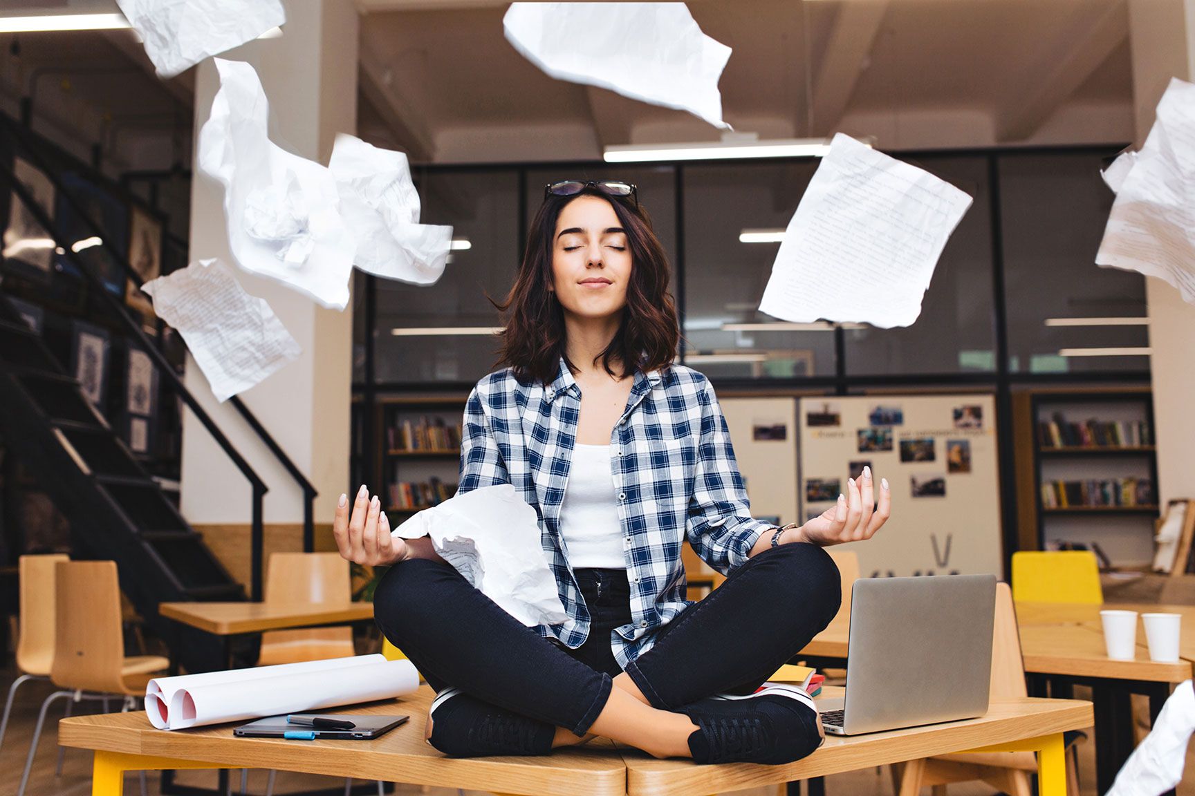 Woman practicing mindfulness at work to manage stress and support heart health.
