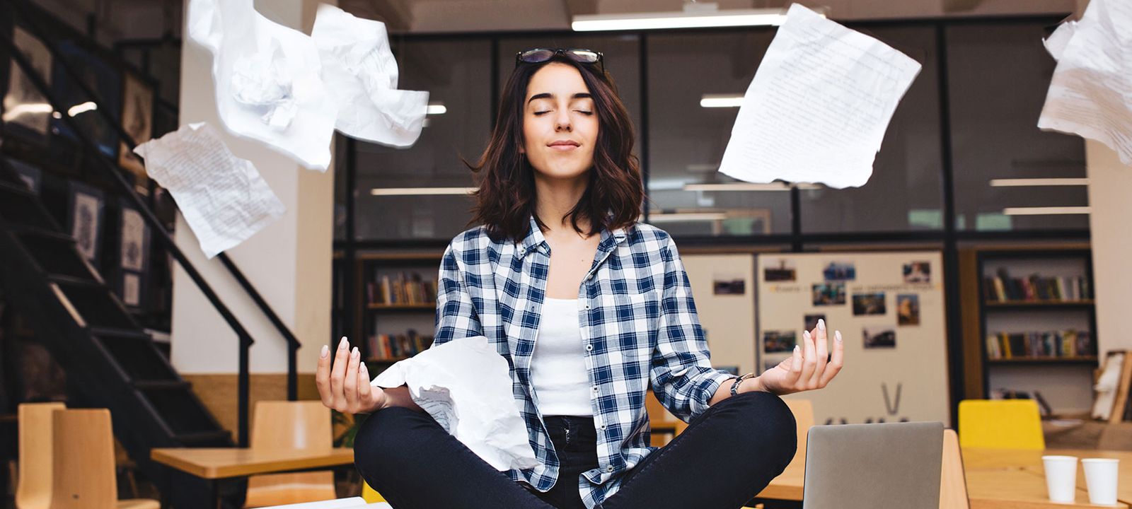 Woman practicing mindfulness at work to manage stress and support heart health.